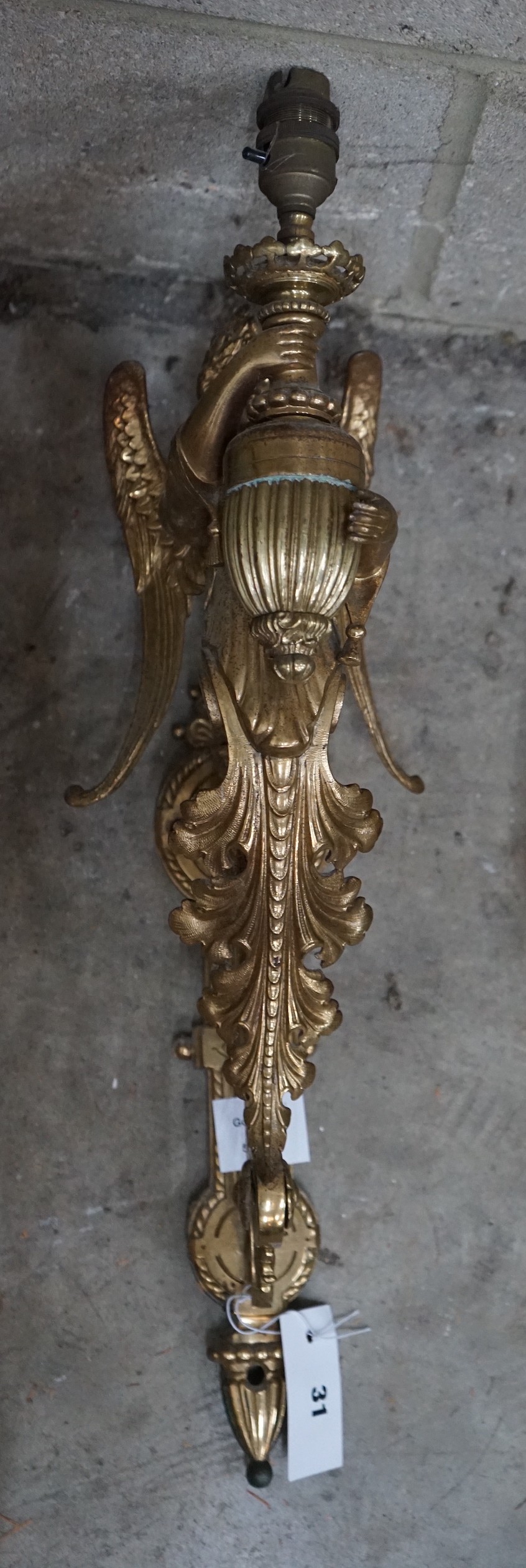 A brass single caryatid wall light, height 50cm